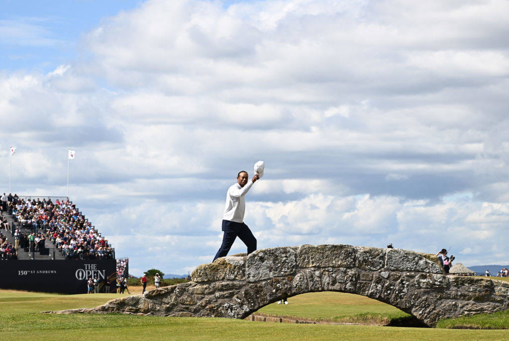 Tiger Woods crosses the Swilcan Bridge